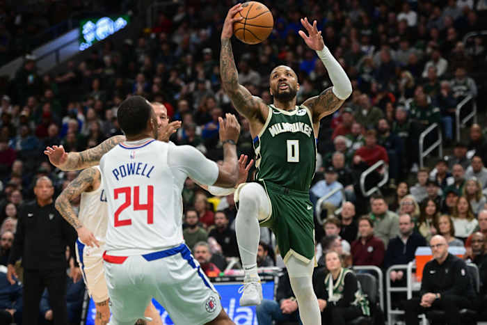 Milwaukee Bucks guard Damian Lillard (0) takes a shot against Los Angeles Clippers guard Norman Powell (24)